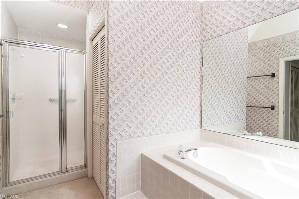 249 St James Way Naples, FL 34104 - Photo 12 of 23 a bathroom with a bathtub and a sink