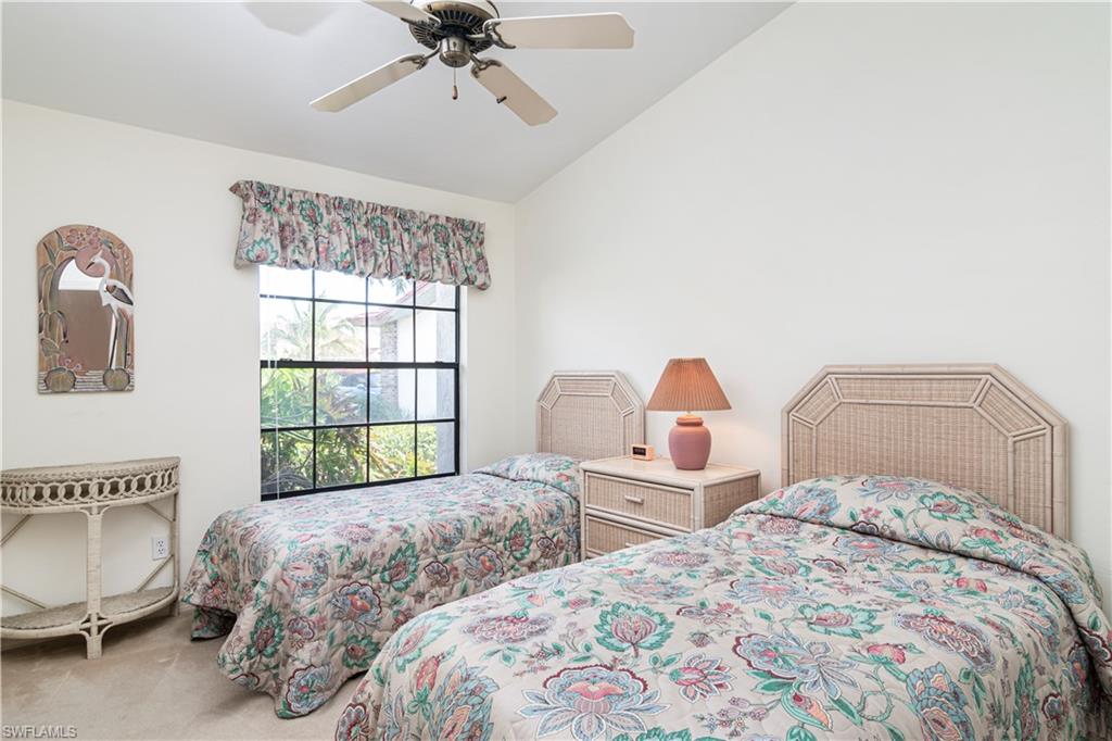 249 St James Way Naples, FL 34104 - Photo 13 of 23 a bedroom with two beds and a window