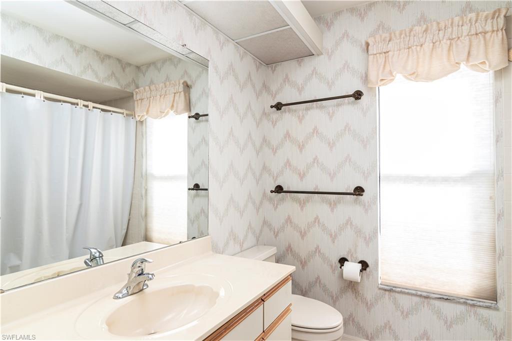 249 St James Way Naples, FL 34104 - Photo 15 of 23 a bathroom with a sink toilet and shower