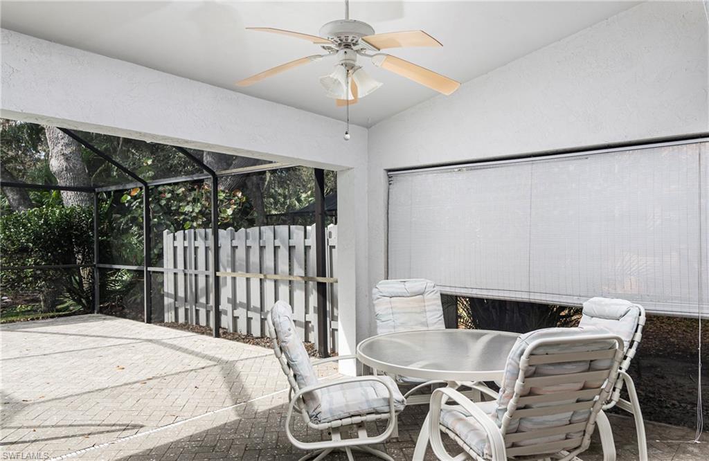249 St James Way Naples, FL 34104 - Photo 17 of 23 a bedroom with a bed a chandelier and a desk