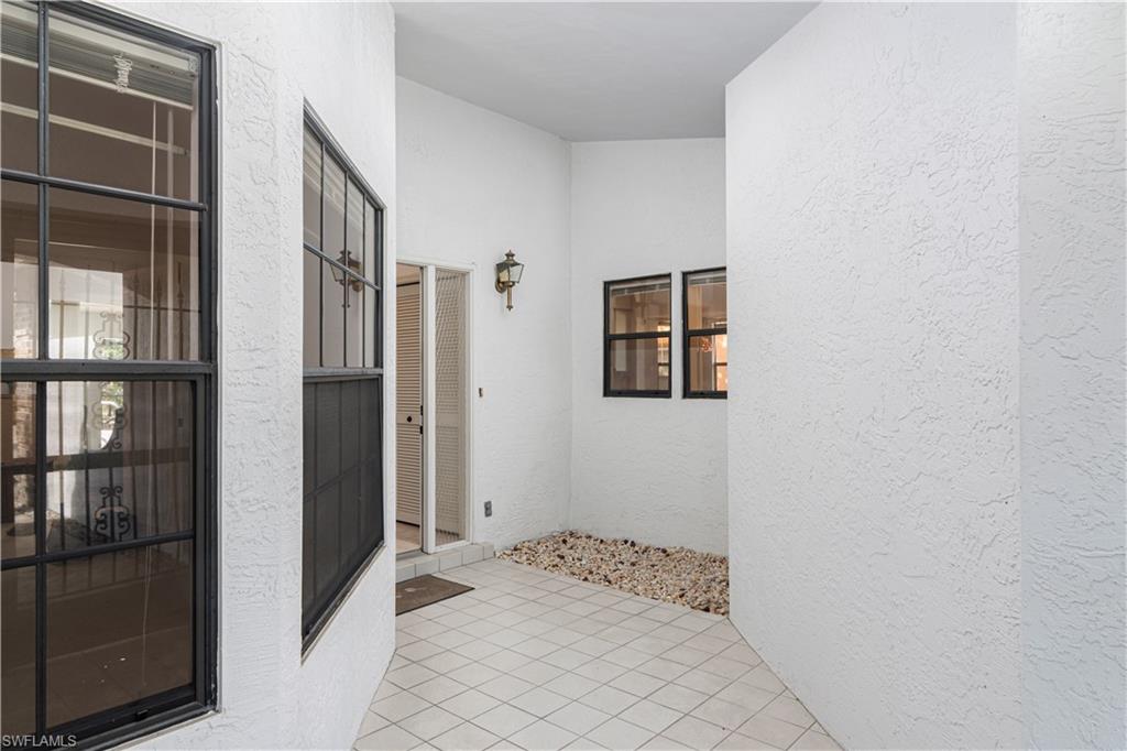 249 St James Way Naples, FL 34104 - Photo 3 of 23 a view of entryway with wooden floor