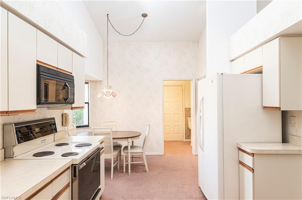 249 St James Way Naples, FL 34104 - Photo 7 of 23 a view of kitchen with stainless steel appliances kitchen island sink stove and refrigerator
