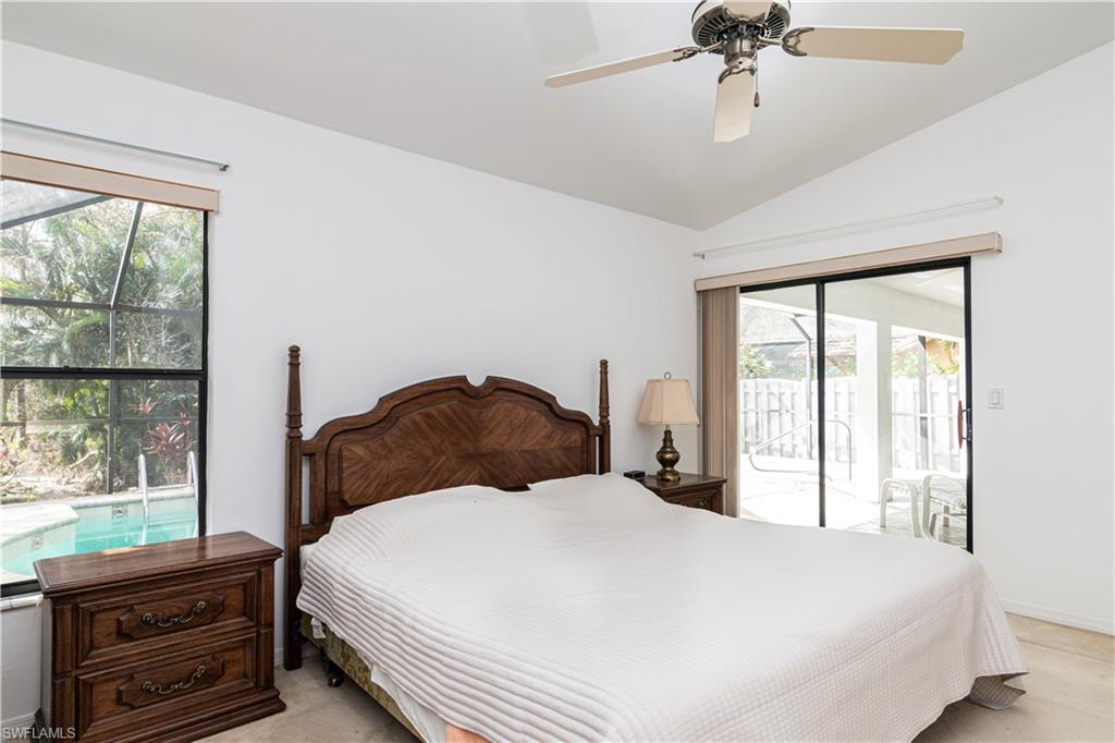 249 St James Way Naples, FL 34104 - Photo 10 of 23 a bedroom with a bed next to a window with a flat tv screen