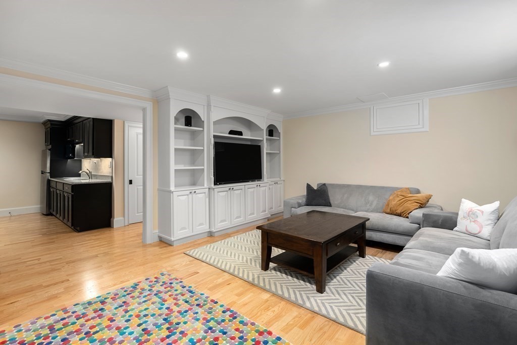 30 Pinecroft Road Weston, MA 02493 - Photo 28 of 38 a living room with furniture and a flat screen tv