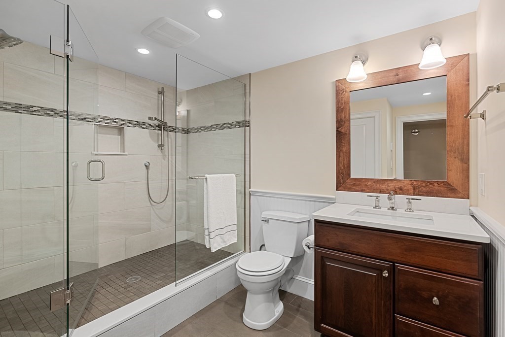 30 Pinecroft Road Weston, MA 02493 - Photo 35 of 38 a bathroom with a shower sink vanity mirror and toilet