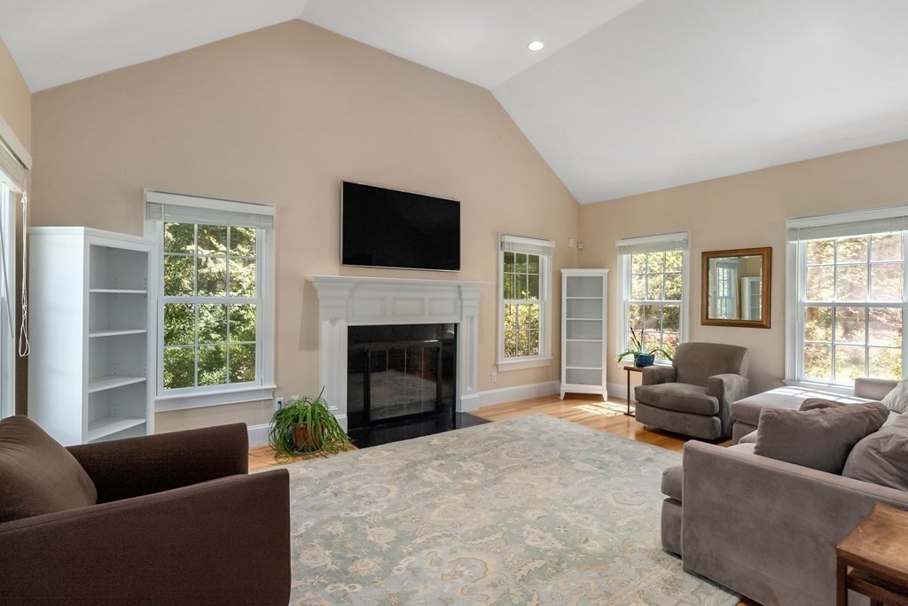 30 Pinecroft Road Weston, MA 02493 - Photo 6 of 38 a living room with furniture a flat screen tv and a fireplace