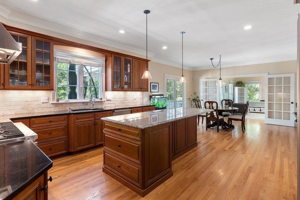 30 Pinecroft Road Weston, MA 02493 - Photo 9 of 38 a kitchen with lots of counter top space and sitting space