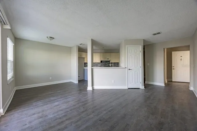 a view of a kitchen with a sink and a refrigerator