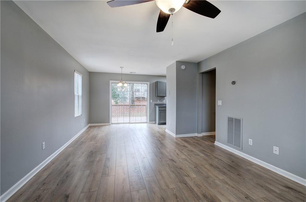 91 Westside Chase Southwest Cartersville, GA 30120 - Photo 14 of 32 an empty room with wooden floor and windows