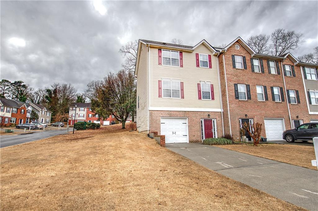 91 Westside Chase Southwest Cartersville, GA 30120 - Photo 2 of 32 a front view of a building with lot of cars and trees