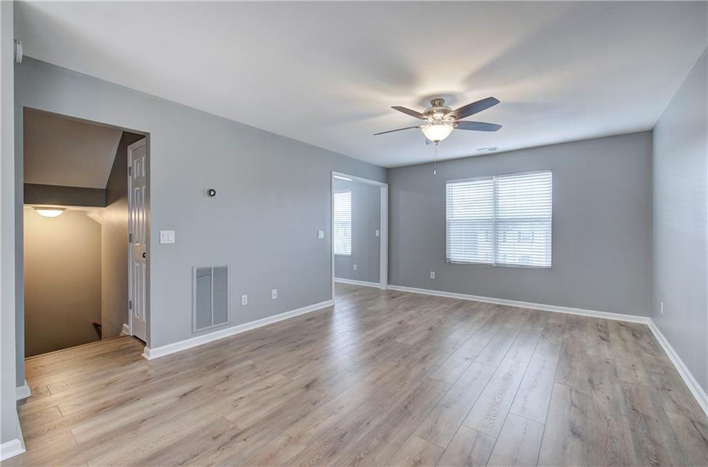 91 Westside Chase Southwest Cartersville, GA 30120 - Photo 7 of 32 a view of an empty room with window and wooden floor