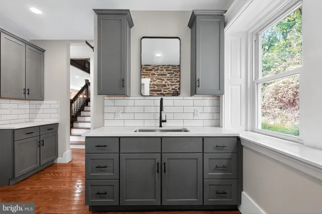 a view of cabinets with wooden floor and window