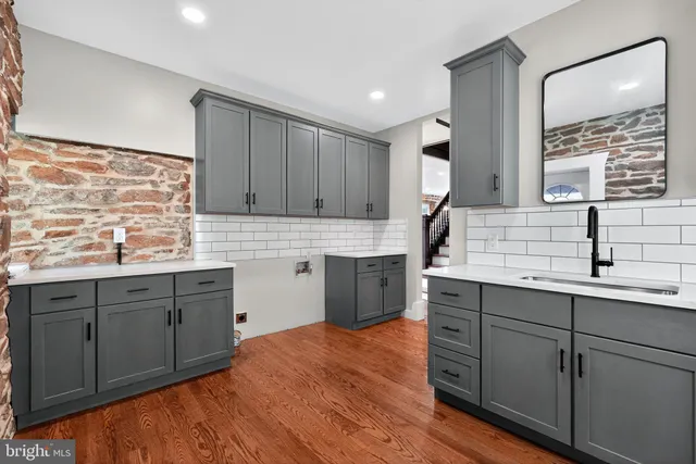 a kitchen with a sink cabinets and window