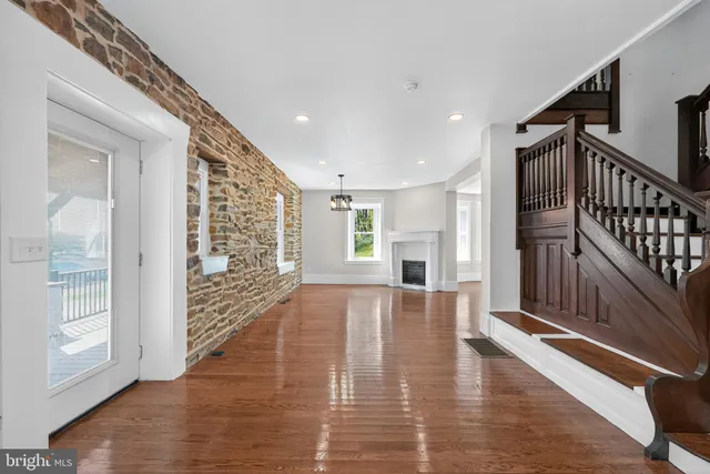 a view of an entryway with wooden floor and windows
