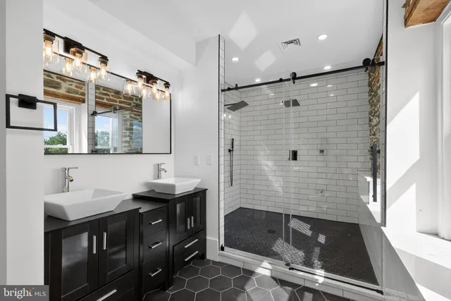 a bathroom with a sink a double vanity and a mirror