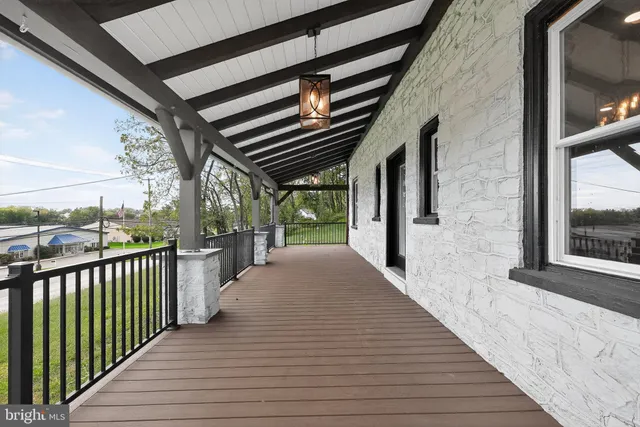 a porch with wooden floor and outer view