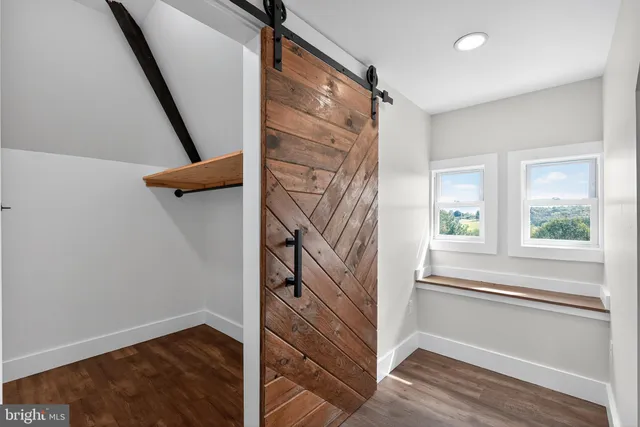 a view of entryway with a window and wooden floor