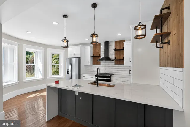 a kitchen with a sink a counter space cabinets and appliances