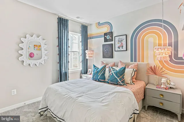 a bedroom with a bed and a painting on the wall