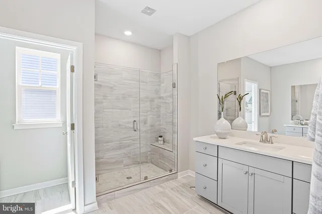 a bathroom with a shower sink and mirror