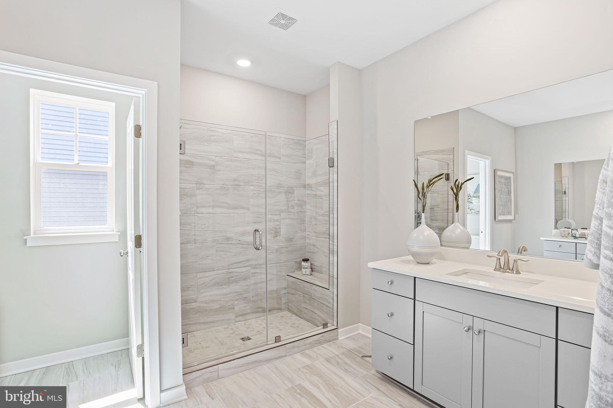 Shenandoah Springs Shenandoah Springs, Unit BRIARS Ranson, WV 25438 - Photo 18 of 23 a bathroom with a shower sink and mirror