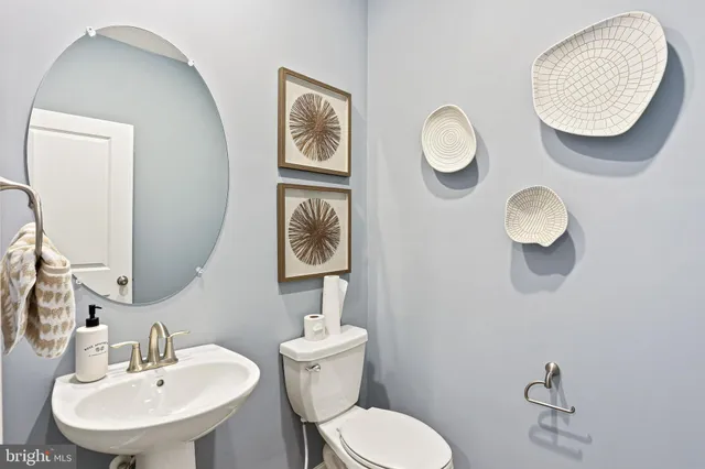 a bathroom with a toilet a sink and mirror