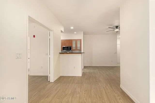 a view of a kitchen with a sink and wooden floor