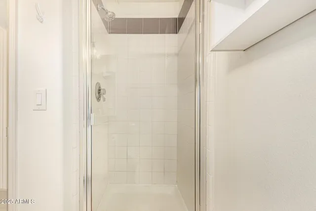 a bathroom with a glass shower door