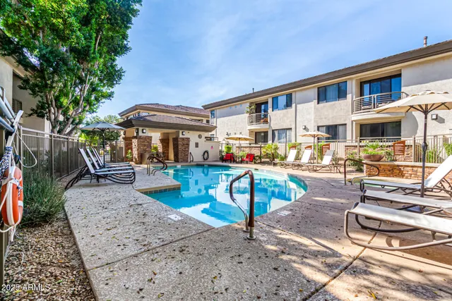 a front view of a house with garden and sitting area