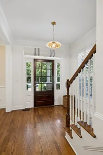 a kitchen with a sink cabinets and wooden floor