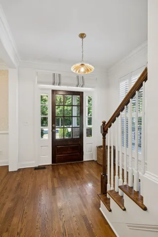 a kitchen with a sink cabinets and wooden floor