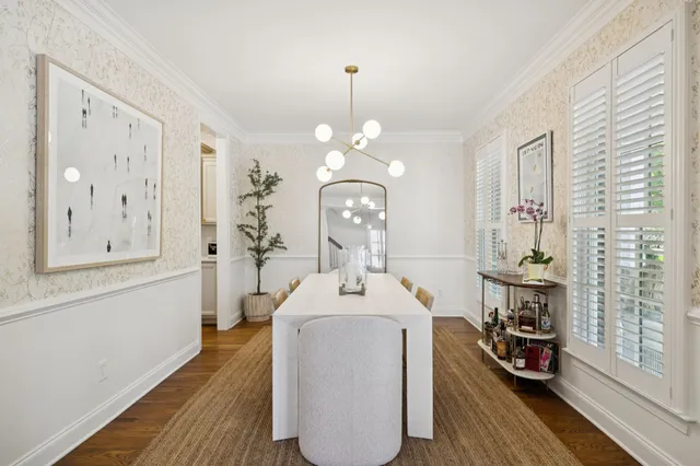 a kitchen with stainless steel appliances granite countertop a stove a sink and white cabinets with wooden floor