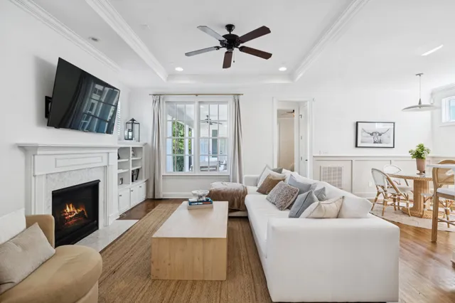 a living room with furniture and kitchen view