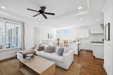 a kitchen with a sink a stove a oven a dining table and chairs