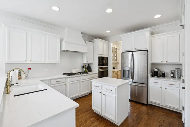 a large living room with stainless steel appliances kitchen island granite countertop a couch and a view of living room