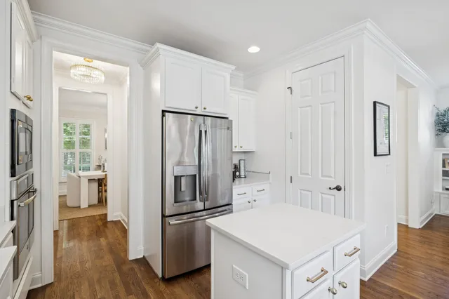 a bedroom with a bed couch and a large window