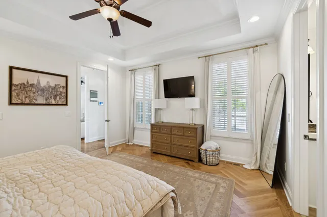 a bedroom with a bed and a chandelier