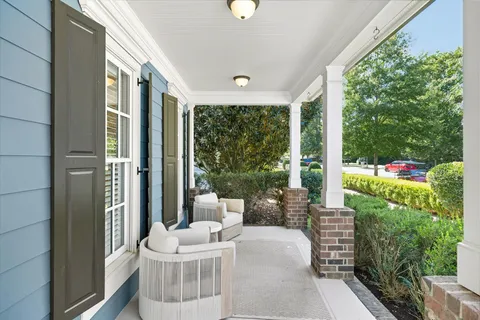a view of a patio with couches table and chairs and potted plants
