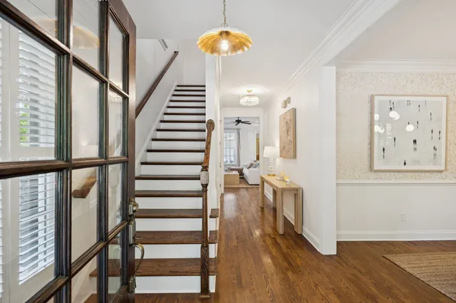 a room with painting on the wall and a wooden floor