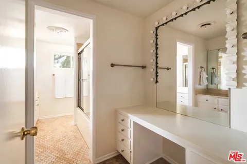 a bathroom with a shower and a sink