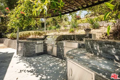a view of a patio with wooden fence