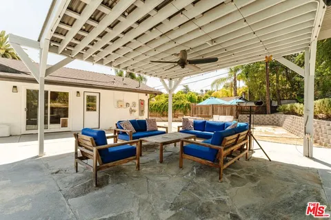 a outdoor living space with furniture and a large tree