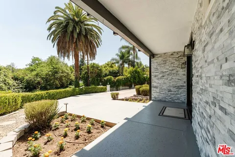 a view of backyard with swimming pool and outdoor seating