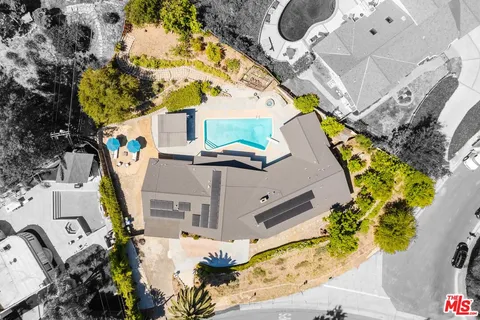 an aerial view of a house with a swimming pool