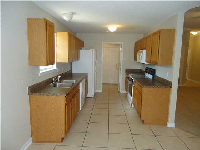 2877 Aplin Road Crestview, FL 32539 - Photo 2 of 17 a kitchen with a sink a counter top space and cabinets
