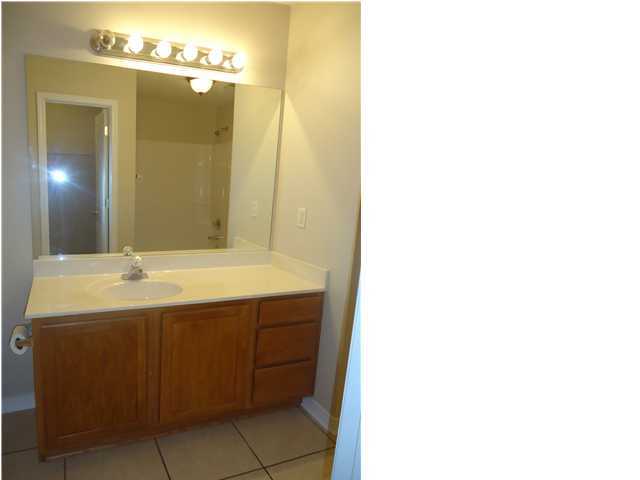 2877 Aplin Road Crestview, FL 32539 - Photo 14 of 17 a bathroom with a sink and a mirror