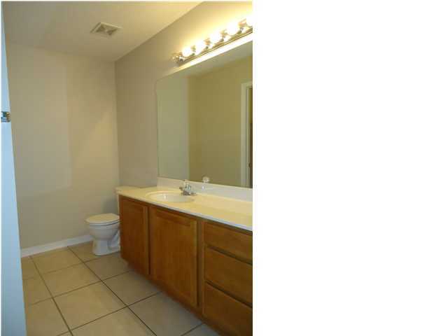 2877 Aplin Road Crestview, FL 32539 - Photo 16 of 17 a bathroom with a sink and mirror