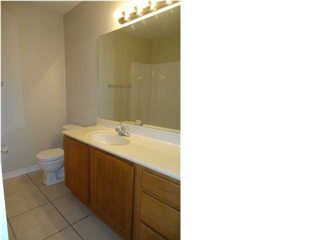 2877 Aplin Road Crestview, FL 32539 - Photo 7 of 17 a spacious bathroom with a granite countertop sink a toilet and a mirror