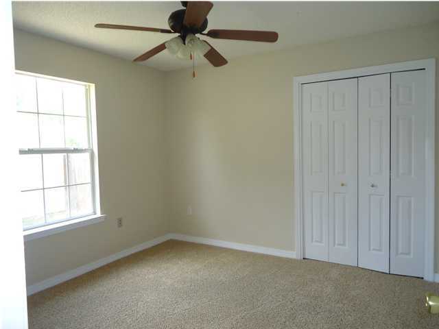 2877 Aplin Road Crestview, FL 32539 - Photo 9 of 17 an empty room with windows and fan