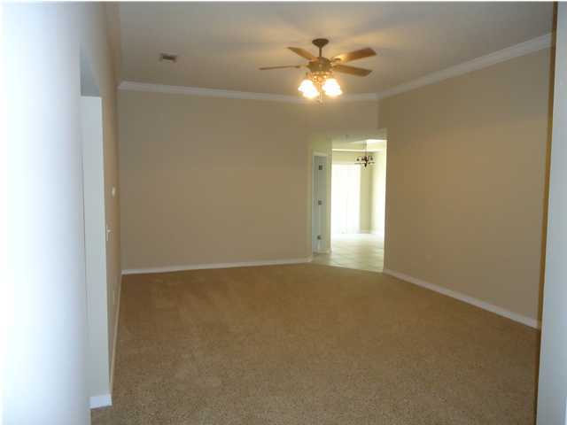 2877 Aplin Road Crestview, FL 32539 - Photo 10 of 17 an empty room with a chandelier fan and a window